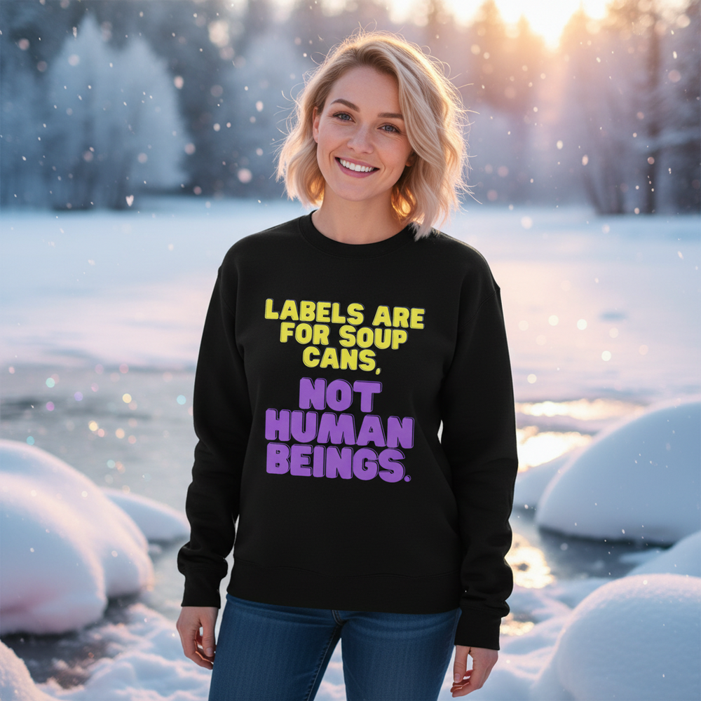 Black sweatshirt reading “Labels Are for Soup Cans, Not Human Beings” worn in a snowy setting