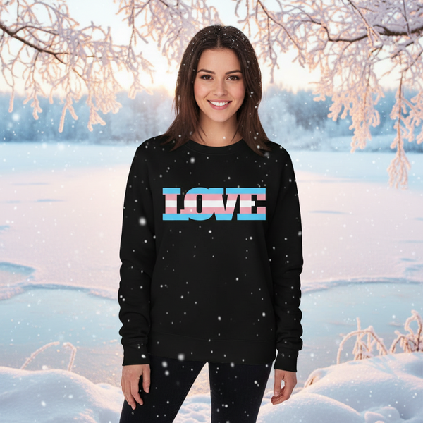 Model wearing a black sweatshirt with pastel-striped “LOVE” lettering in a snowy setting