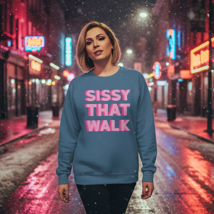 Sissy That Walk Unisex Sweatshirt: A person confidently strolls a neon-lit street, showcasing a blue sweatshirt with bold pink lettering, embodying proud self-expression and LGBTQIA+ pride.