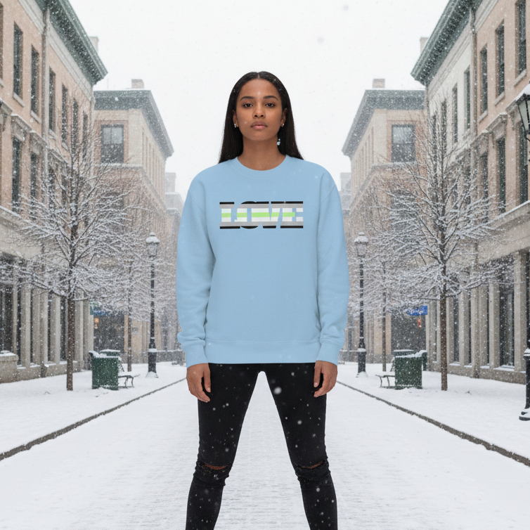 Young woman in a snow-covered street wearing the Agender Love Unisex Sweatshirt, featuring LOVE in striped letters, embodying LGBTQ pride and warmth with its soft, inclusive design, perfect for self-expression.