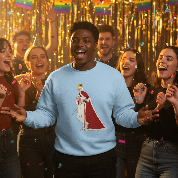 A jubilant scene shows a Black man at a Pride celebration wearing the Queen Freddy Mercury Unisex Sweatshirt, featuring a crowned monarch design, embodying empowerment, visibility, and joyful queer self-expression.