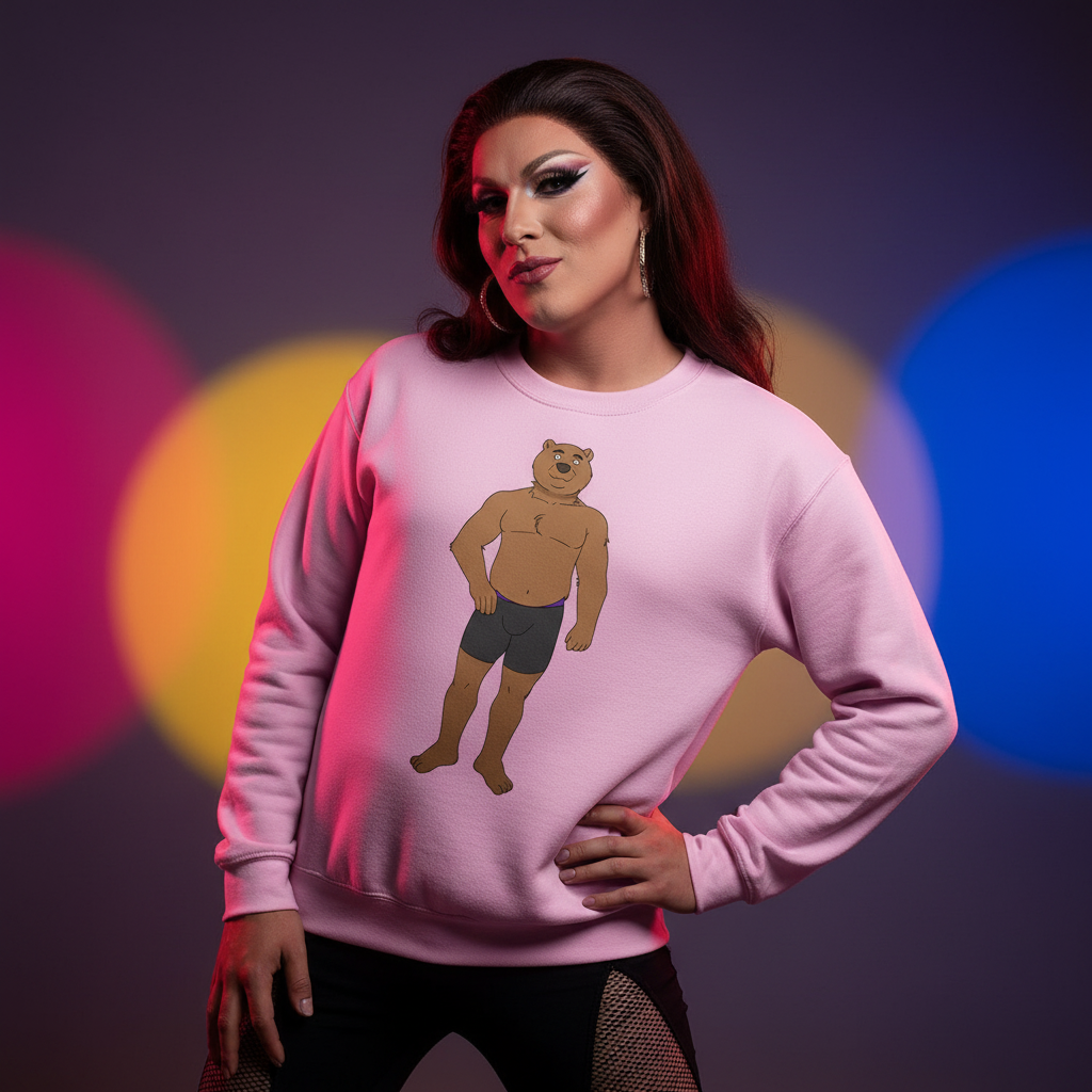 Person poses confidently in a Gay Cub Unisex Sweatshirt, featuring a cartoon muscular bear graphic. The pink crewneck embodies queer pride, empowerment, and playful self-expression, perfect for every LGBTQIA+ wardrobe.