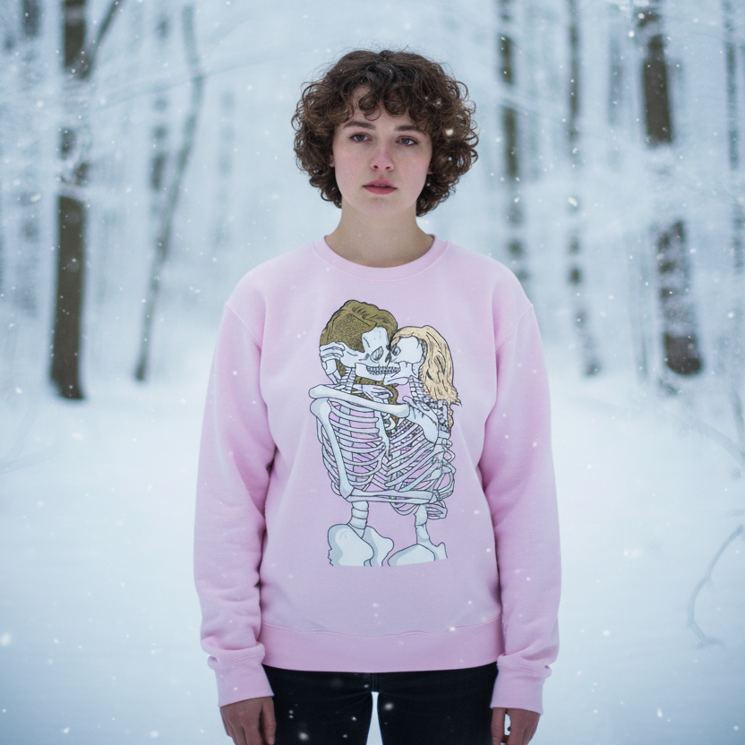 Queer Skeletons Unisex Sweatshirt: A cozy, pale pink sweatshirt with an embracing skeleton print, perfect for expressing pride and warmth in a snow-covered forest, embodying joyful queer energy.