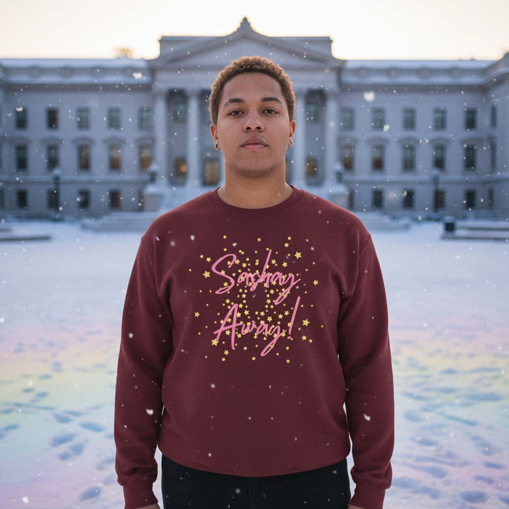 Model wearing a burgundy sweatshirt with pink “Sashay Away” lettering and gold stars in falling snow