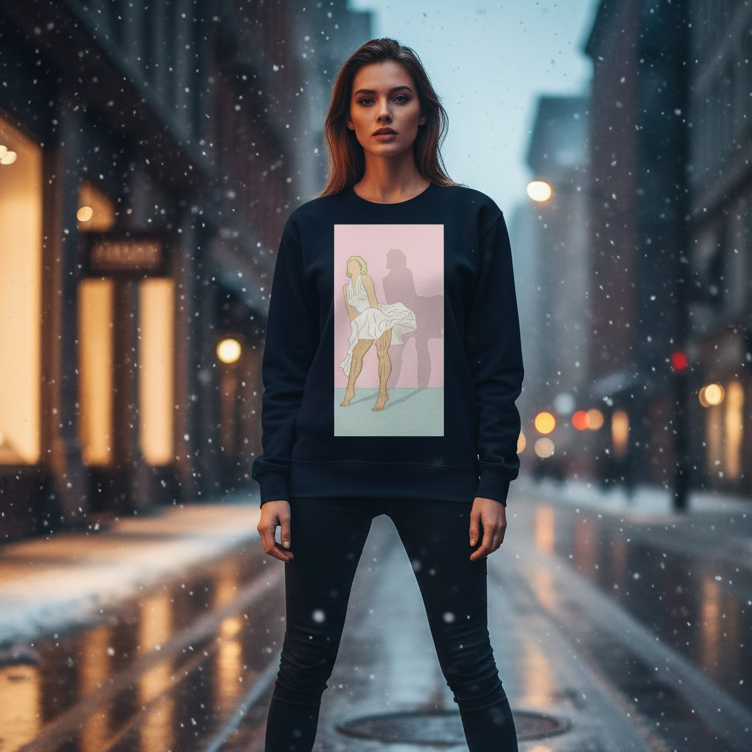 Woman wearing the Daddy Monroe Unisex Sweatshirt, featuring a bold illustration of a blonde woman, stands in a snow-dusted city street at dusk, embodying queer pride, warmth, and self-expression.