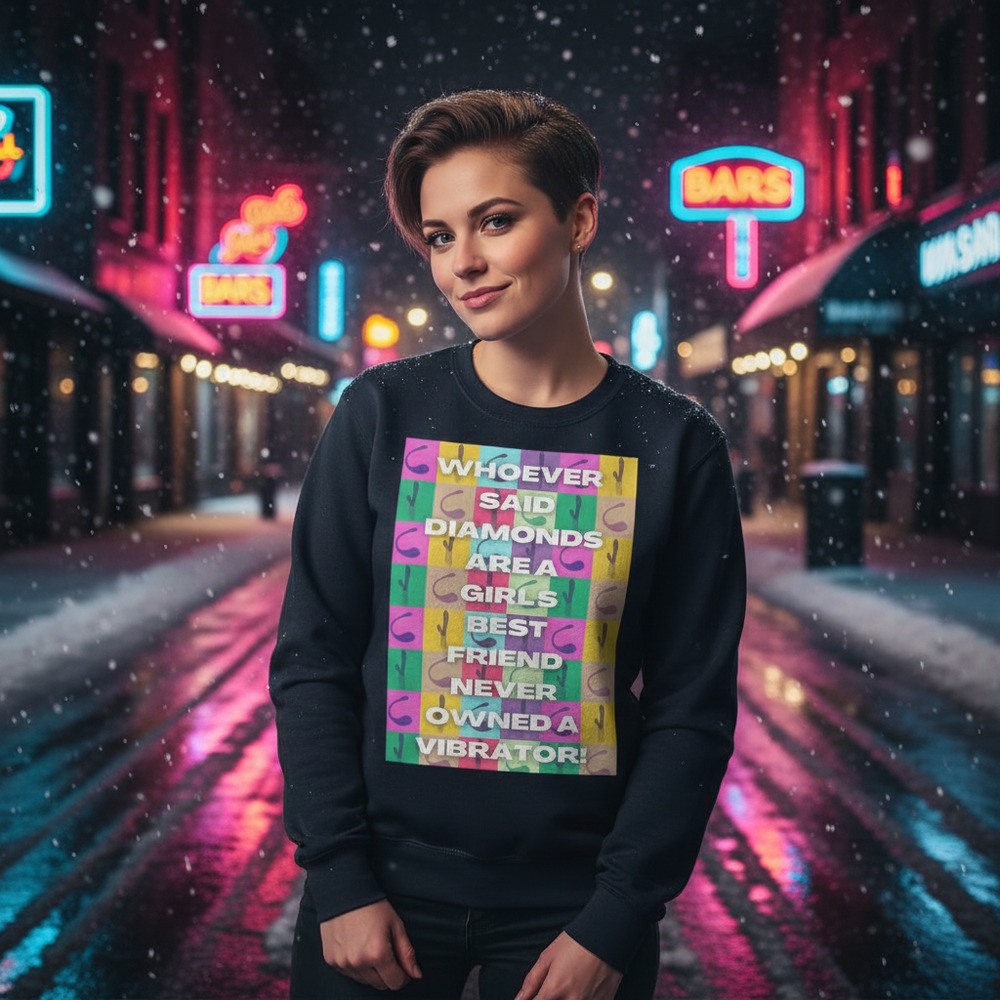 Person wearing a black sweatshirt with a colorful vibrator-themed slogan in a snowy neon street