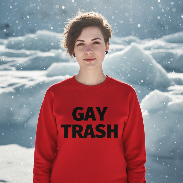Person wearing a red sweatshirt reading “GAY TRASH” in black, standing in falling snow