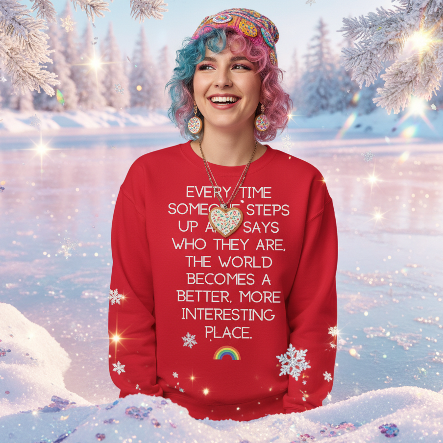 Young person in a snowy setting wearing the Every Time Someone Stands Up Unisex Sweatshirt. The bold red garment features an empowering message, perfect for celebrating pride, visibility, and self-expression.