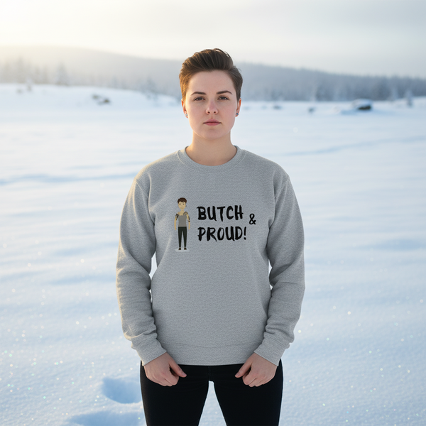 Model wearing a gray sweatshirt with a cartoon figure and “BUTCH & PROUD!” text in a snowy landscape