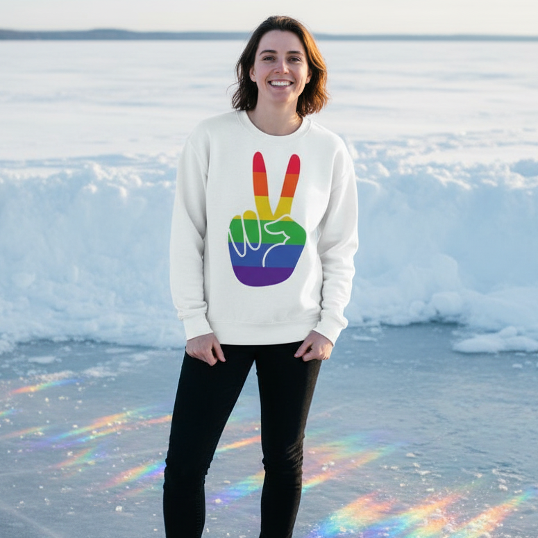 Person wearing a white sweatshirt with a rainbow peace-sign graphic on a frozen lake