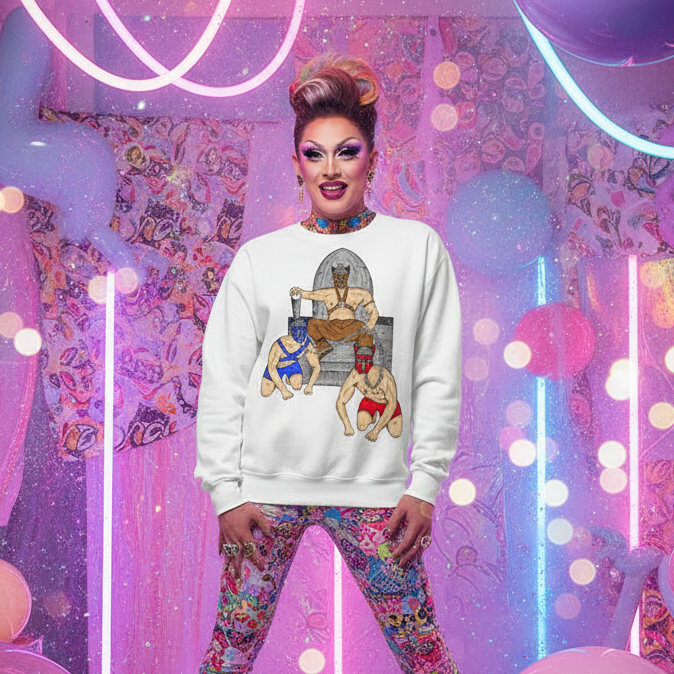 Drag performer modeling a white sweatshirt with a crowned wrestler and two dogs graphic
