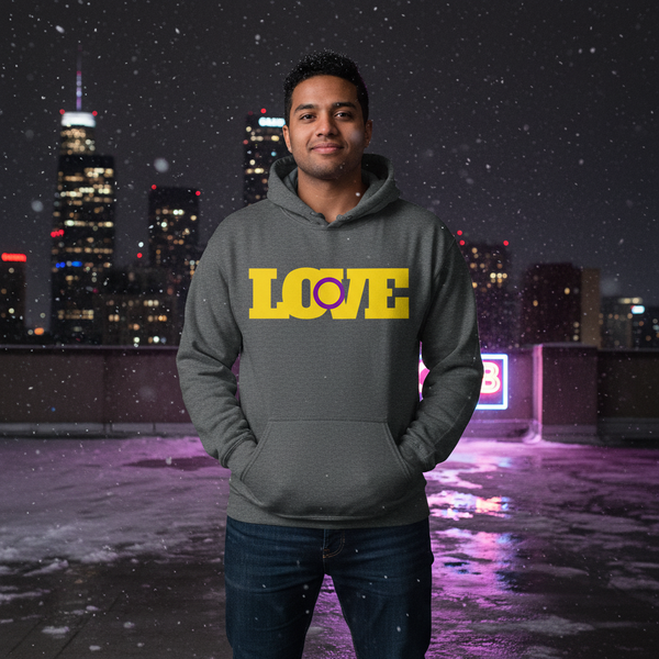 Person wearing a dark gray hoodie with bold yellow and purple LOVE graphic on a snowy rooftop at night