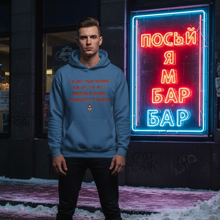 person models a blue hoodie with red text on a snowy sidewalk beside a neon bar sign