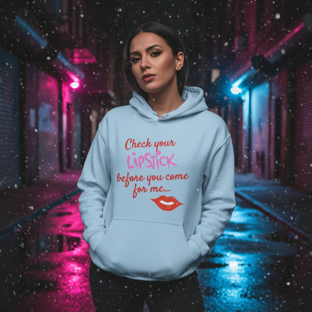Model wearing a light blue hoodie reading “Check your lipstick before you come for me…”