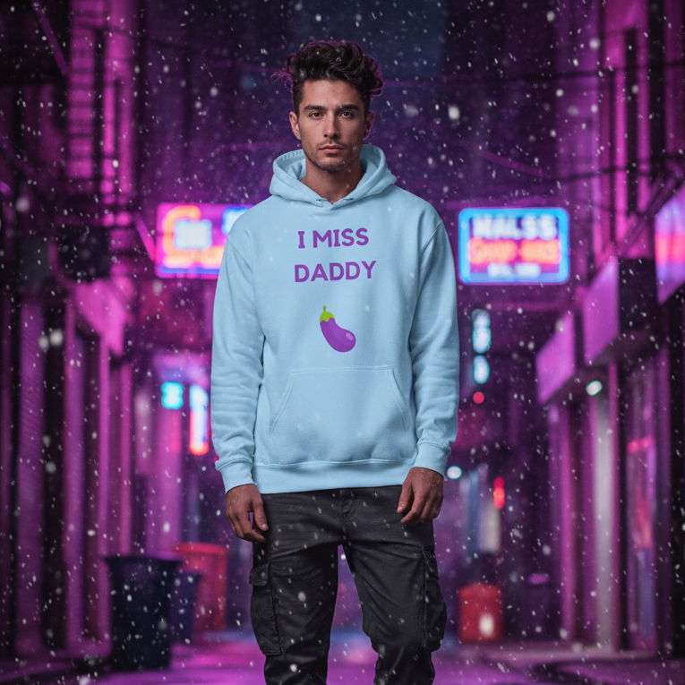 Person modeling a light blue hoodie reading “I MISS DADDY” with an eggplant graphic