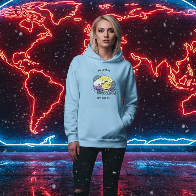 Young woman in a light-blue Unisex Hoodie with a playful cartoon graphic, embodying queer pride in front of a neon-lit world map. The hoodie radiates comfort and inclusivity, perfect for empowering self-expression.