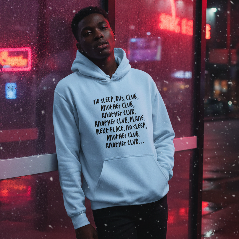 Model wearing a light blue hoodie with black text in a neon-lit snowy night scene