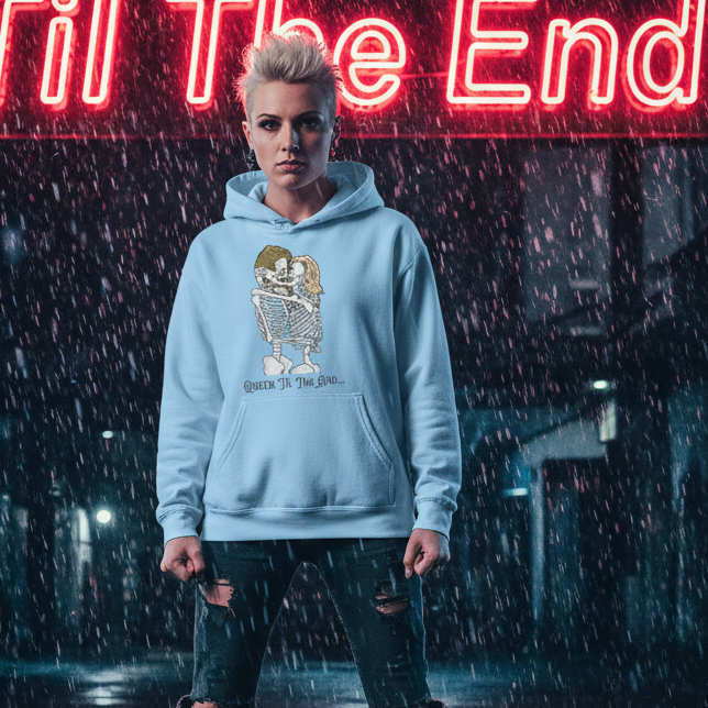 Queer Til The End Unisex Hoodie worn by a young person in a moody, neon-lit alley, featuring a skeleton embrace graphic. Ideal for expressing pride and self-expression, this cozy, stylish hoodie is perfect for cooler nights.