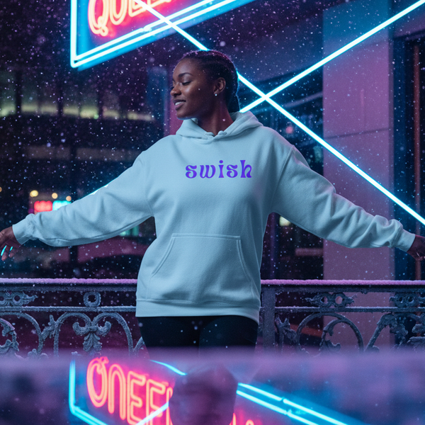 Model wearing a light blue hoodie with purple “swish” text in falling snow