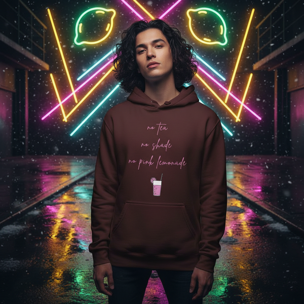 Model wearing a brown hoodie reading “No Tea No Shade No Pink Lemonade” in a neon-lit alley