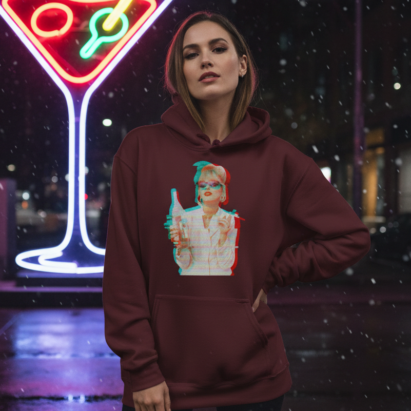 Model wearing a burgundy hoodie with a retro glitch-style portrait graphic, outdoors at night in falling snow