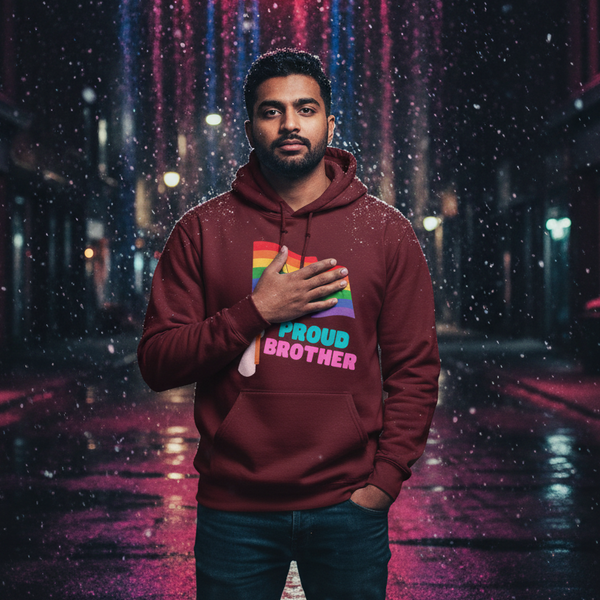 Person wearing a burgundy hoodie with a rainbow flag and “PROUD BROTHER” text on a rainy street