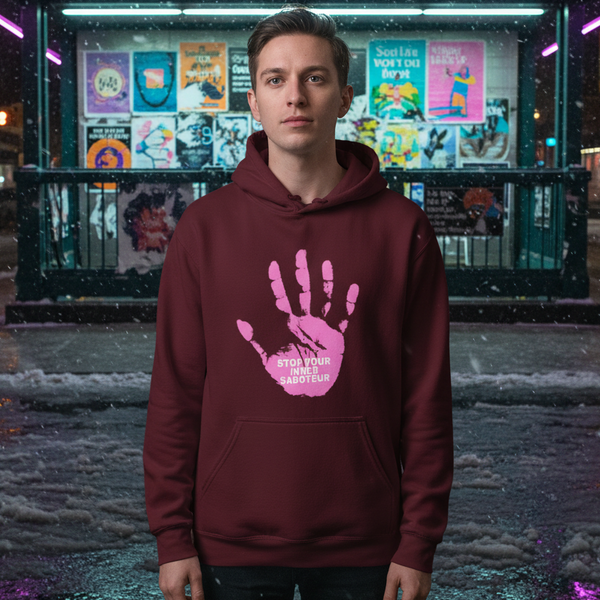Model wearing a burgundy hoodie with a pink handprint and “STOP YOUR INNER SABOTEUR” text