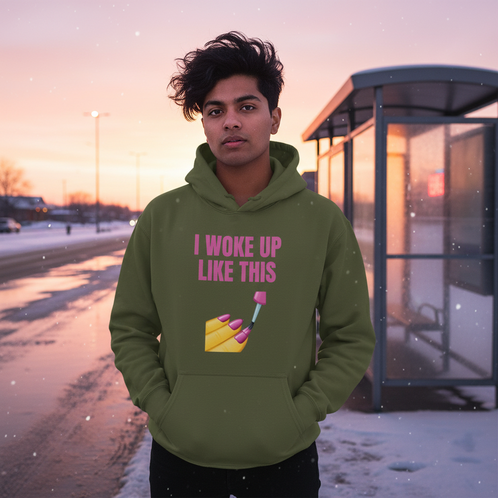 Person wearing an olive hoodie reading “I WOKE UP LIKE THIS” beside a snowy bus shelter