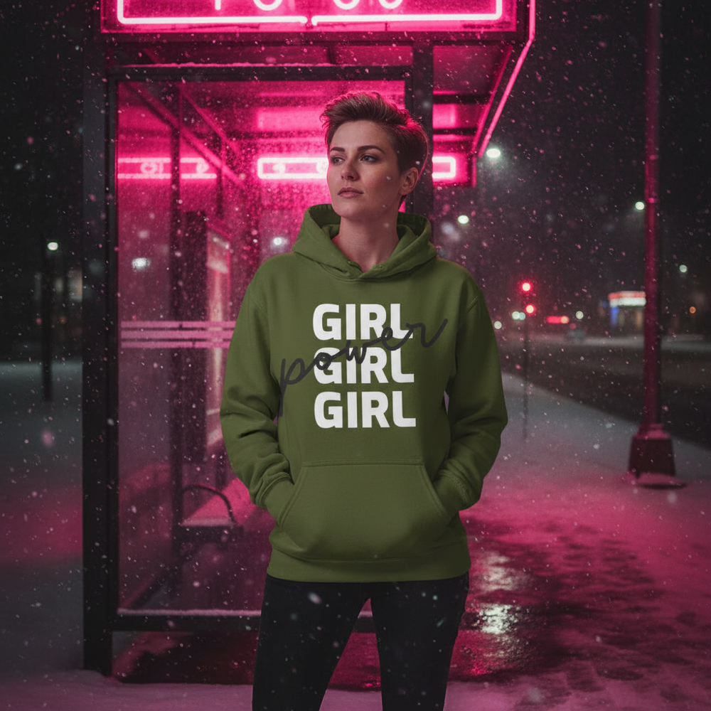 Person wearing an olive-green hoodie reading “GIRL GIRL GIRL” with black script overlay