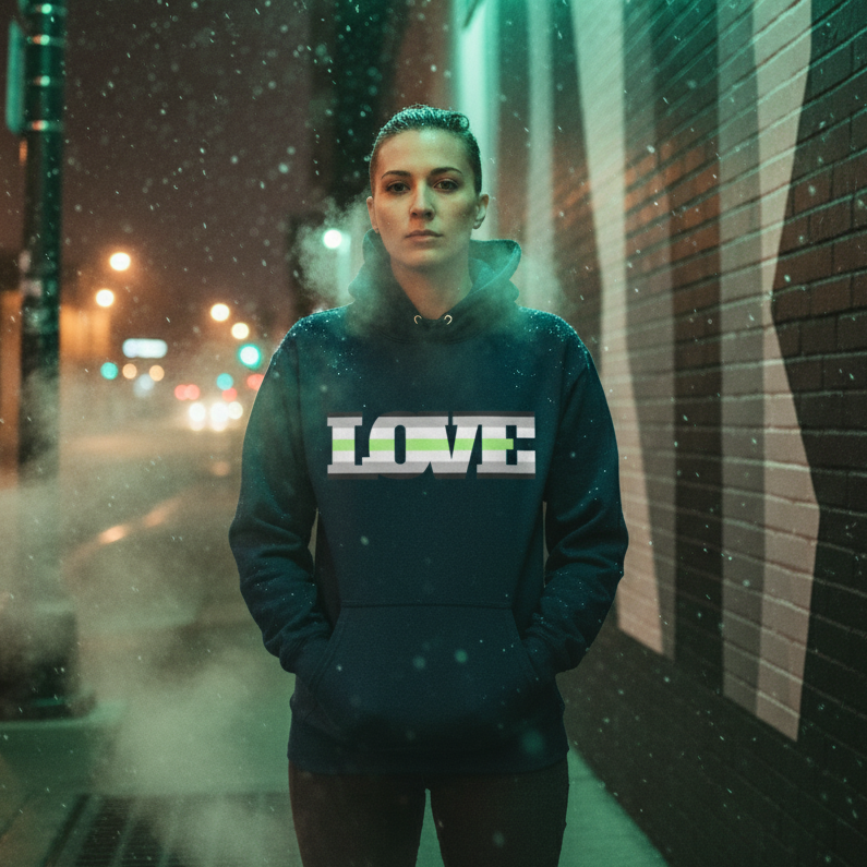 Person wearing a dark hoodie with bold LOVE lettering on a snowy city sidewalk