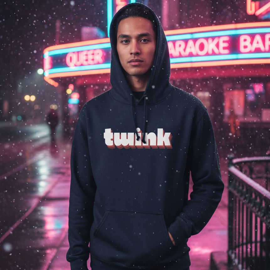 Young person wearing the Twink Unisex Hoodie stands on a neon-lit city sidewalk at night, with gentle snowfall around them, reflecting Queer Karaoke Bar's vibrant glow, embodying pride and self-expression.