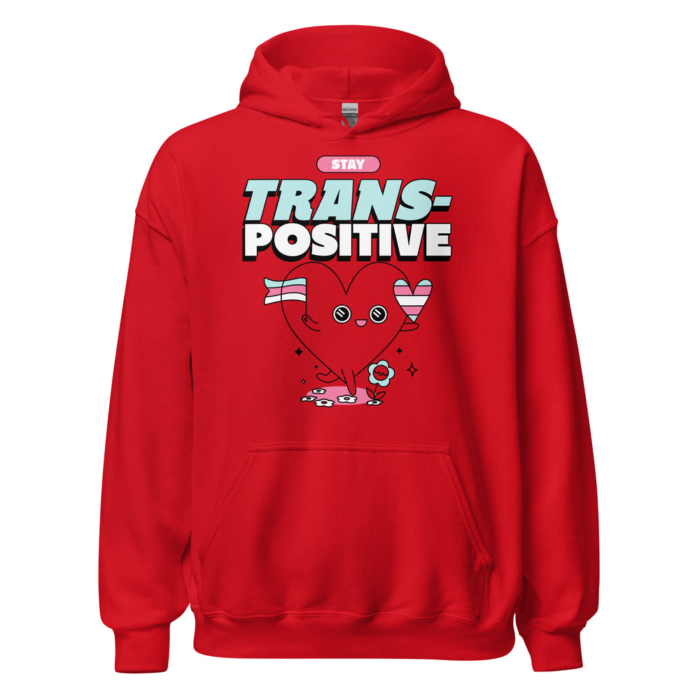 Front view of a red hoodie with “STAY TRANS-POSITIVE” text and a heart holding trans flags