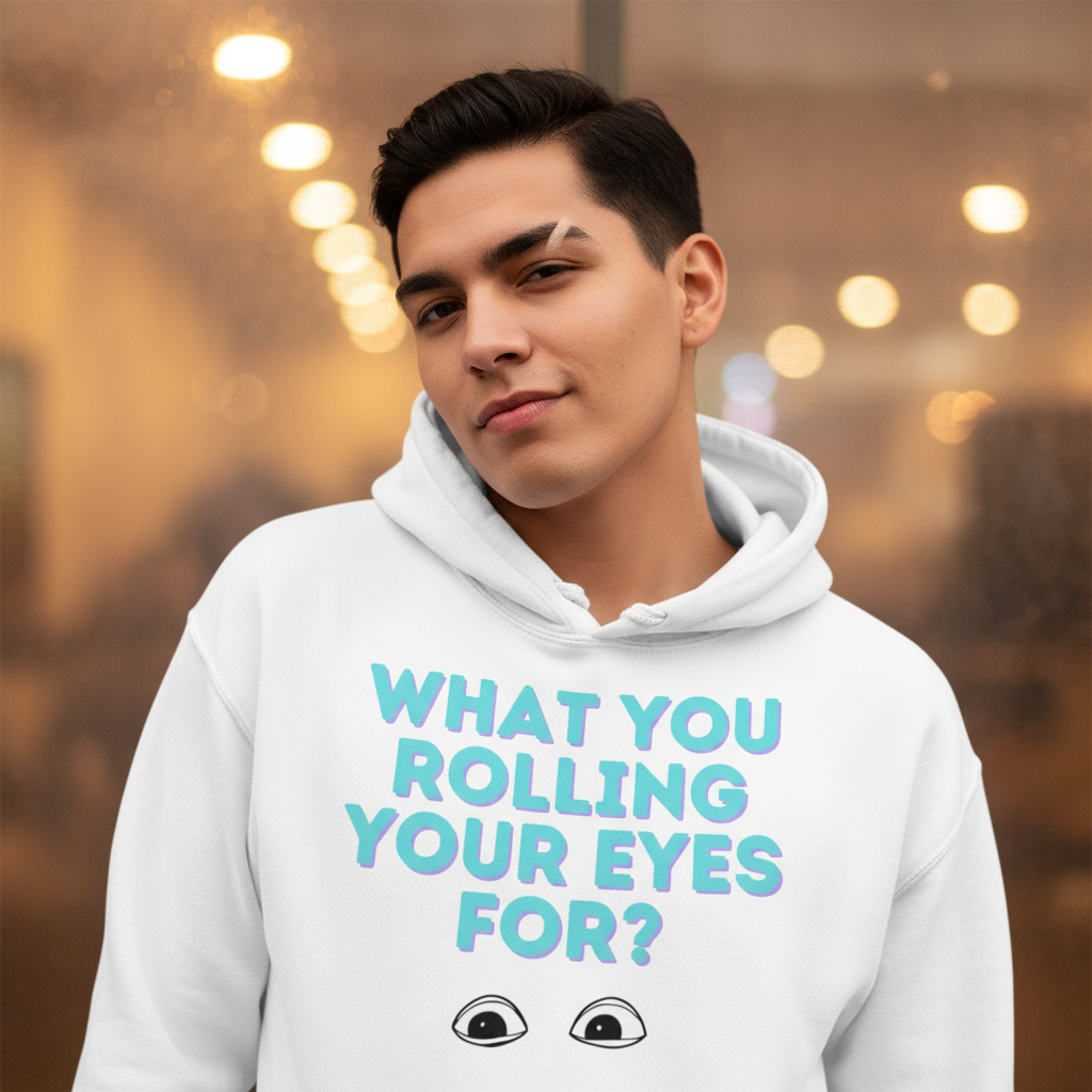 Young man wearing What You Rolling Your Eyes For? Unisex Hoodie, showcasing bold teal-and-purple text and cartoon eyes. This cozy, inclusive hoodie embraces pride, self-expression, and comfort for all gender identities.