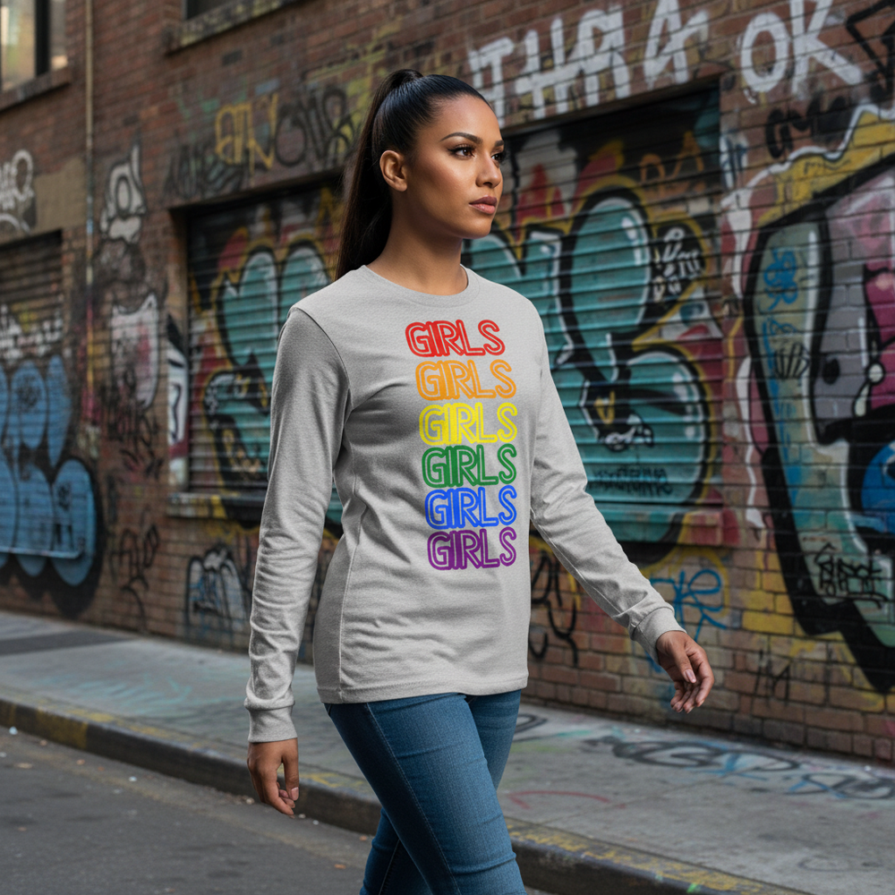 Girls Girls Girls light gray unisex long sleeve tee with “GIRLS” six times in rainbow, worn proudly with classic jeans.