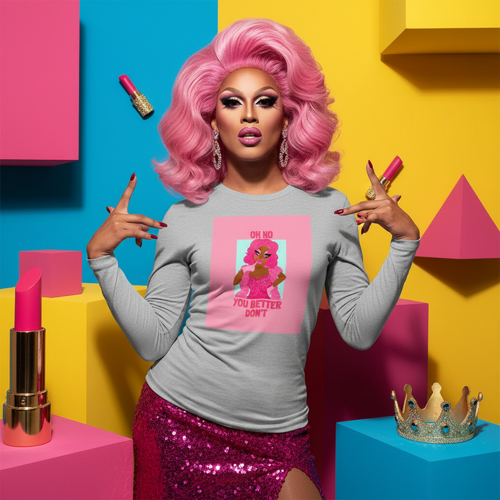 Drag performer in a gray long-sleeve shirt reading “OH NO YOU BETTER DON’T”