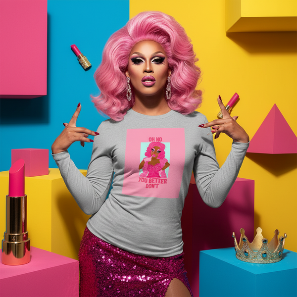 Drag performer in a gray long-sleeve shirt reading “OH NO YOU BETTER DON’T”