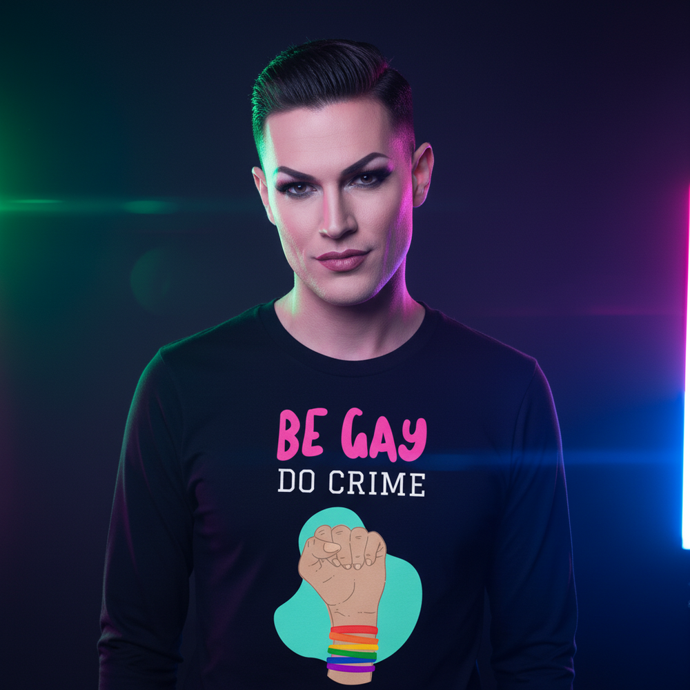 Model wearing a black long-sleeve shirt reading “BE GAY DO CRIME” with a raised fist
