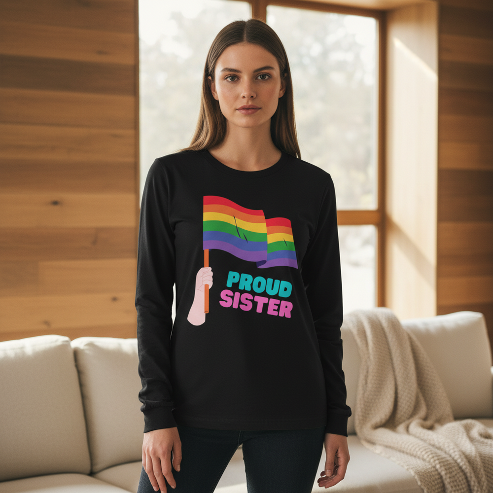 Front-facing model wearing a black long-sleeve shirt with a rainbow flag and “PROUD SISTER” text