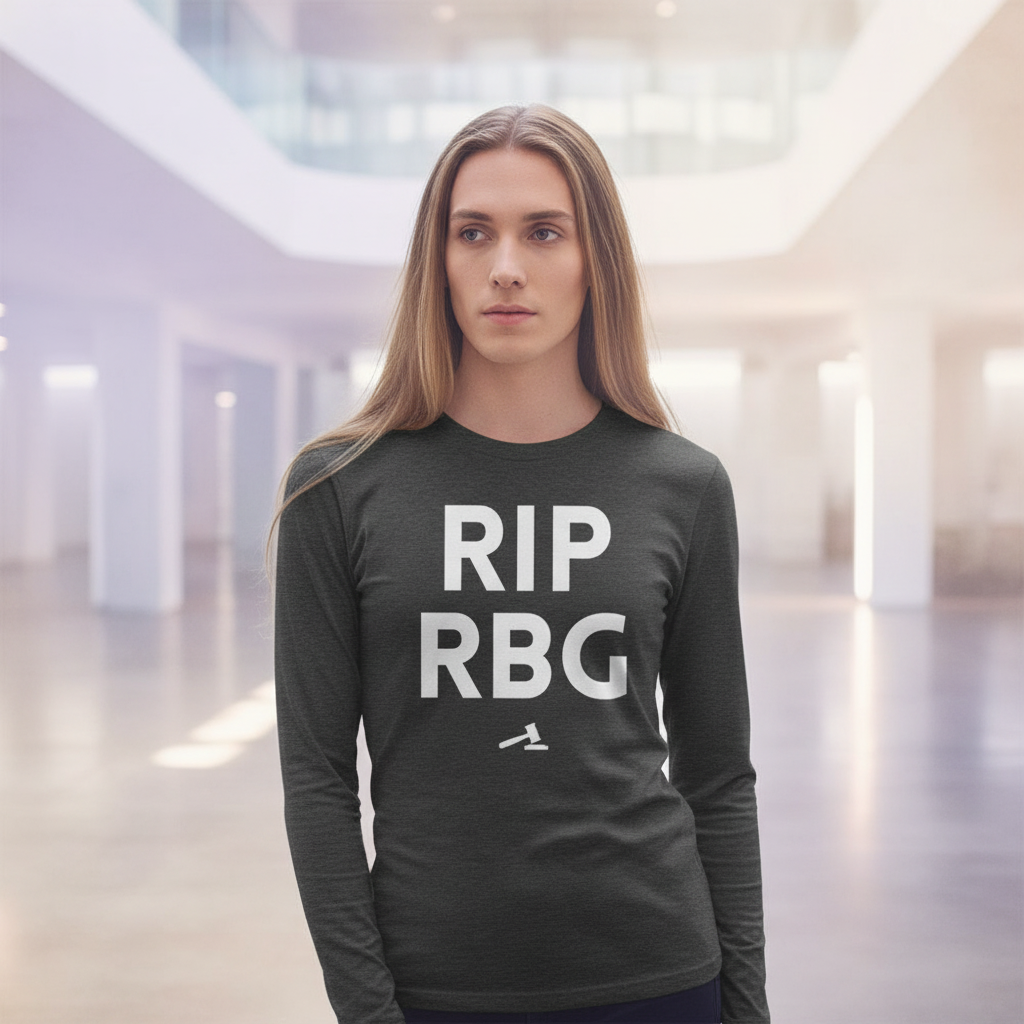 RIP RBG unisex long sleeve tee in bright white text, worn by a femme with long light brown hair, lit by soft indoor sunlight.