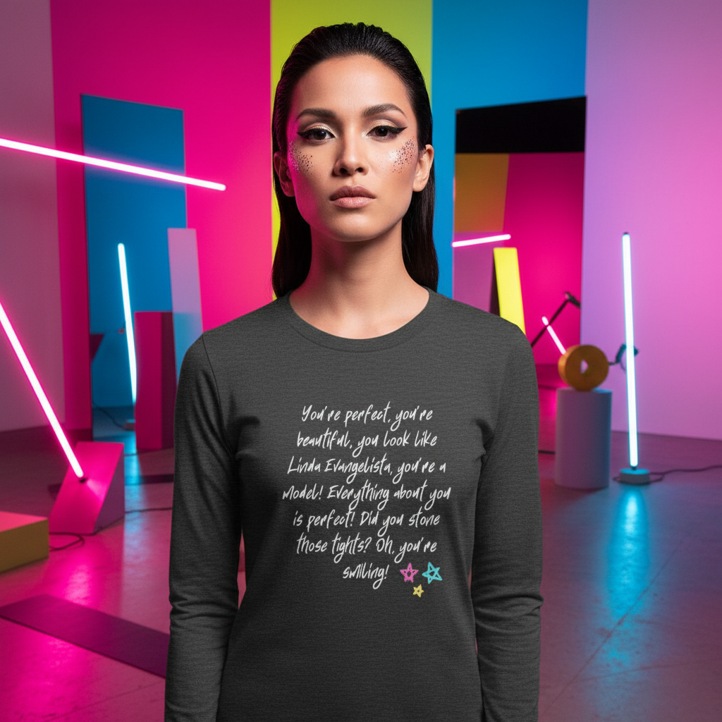 The You Look Like Linda Evangelista Unisex Long Sleeve T-Shirt features bold white cursive text celebrating self-expression, worn by a confident, stylish woman in a vibrant, prideful setting.