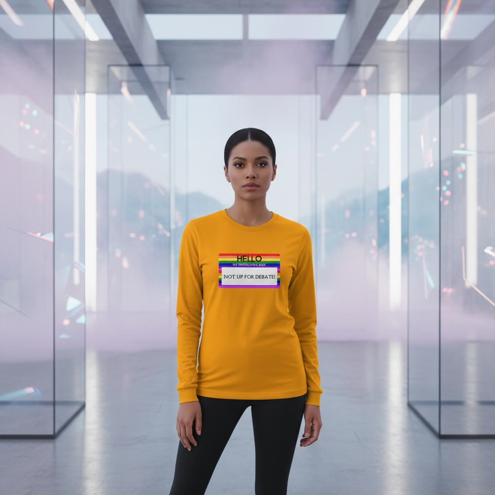 Yellow unisex long sleeve tee reads "Hello My Pronouns Are Not Up For Debate" with a rainbow-striped pronoun name tag.