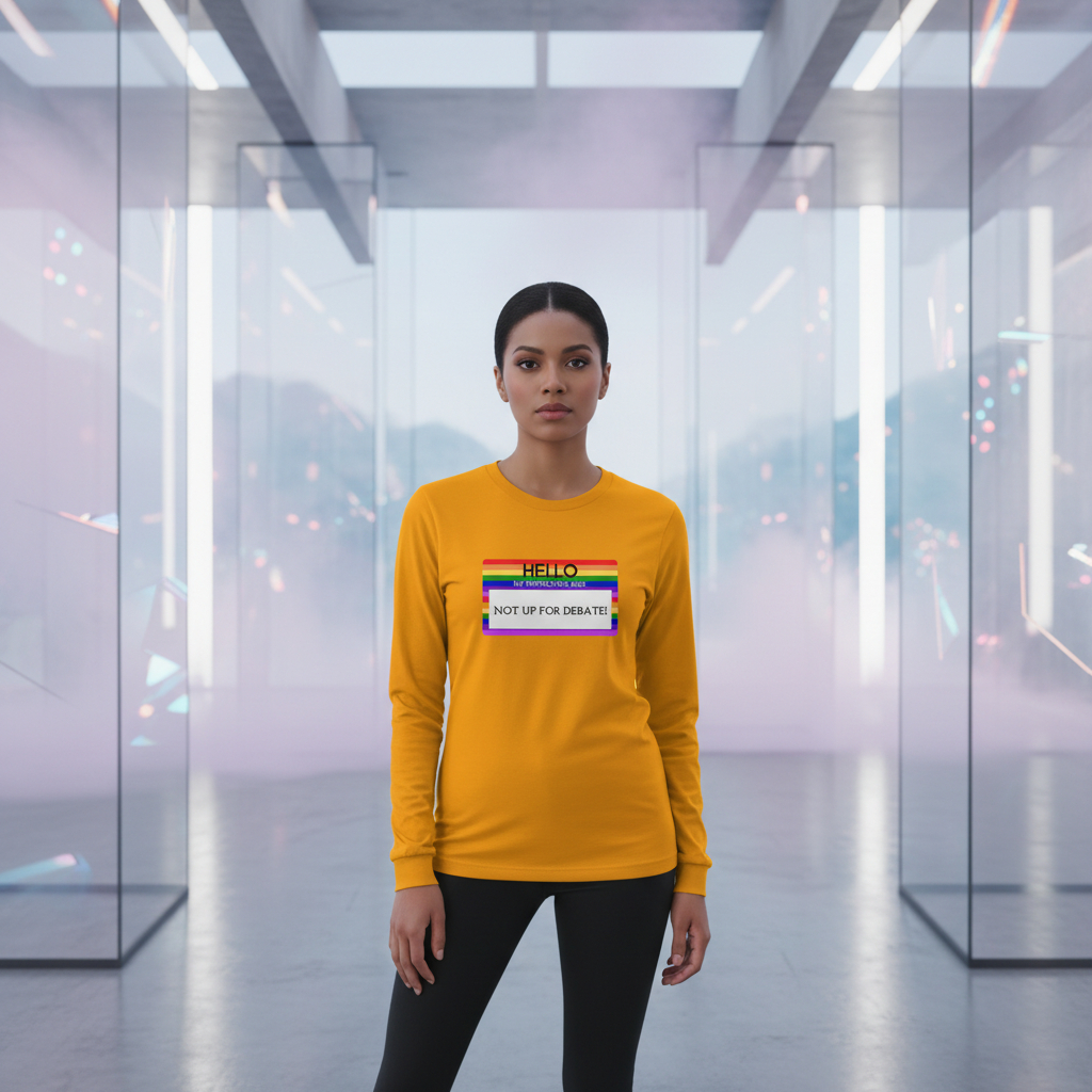 Yellow unisex long sleeve tee reads "Hello My Pronouns Are Not Up For Debate" with a rainbow-striped pronoun name tag.