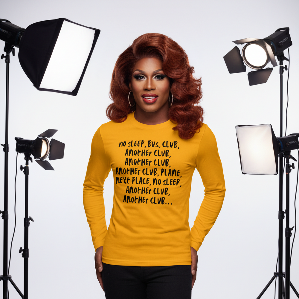 Front view of a person wearing a mustard long-sleeve shirt with black club-themed text