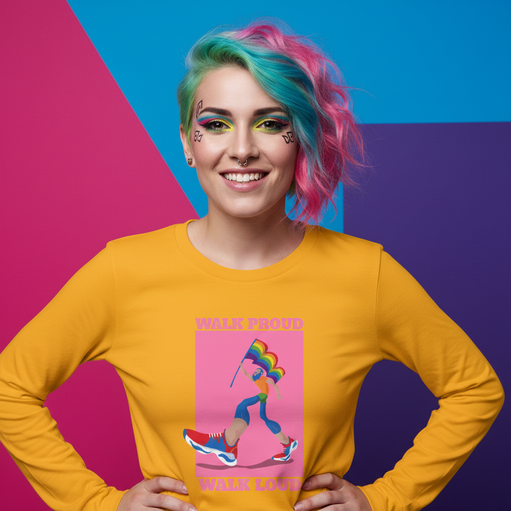 Person in a yellow long-sleeve shirt reading “WALK PROUD WALK LOUD” with a rainbow-flag illustration