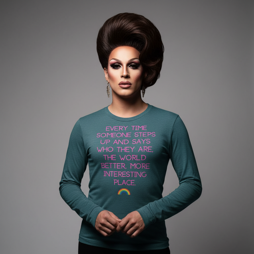 Teal “Every Time Someone Steps Up” unisex long sleeve tee with rainbow graphic, worn by model with bold makeup and big hair.