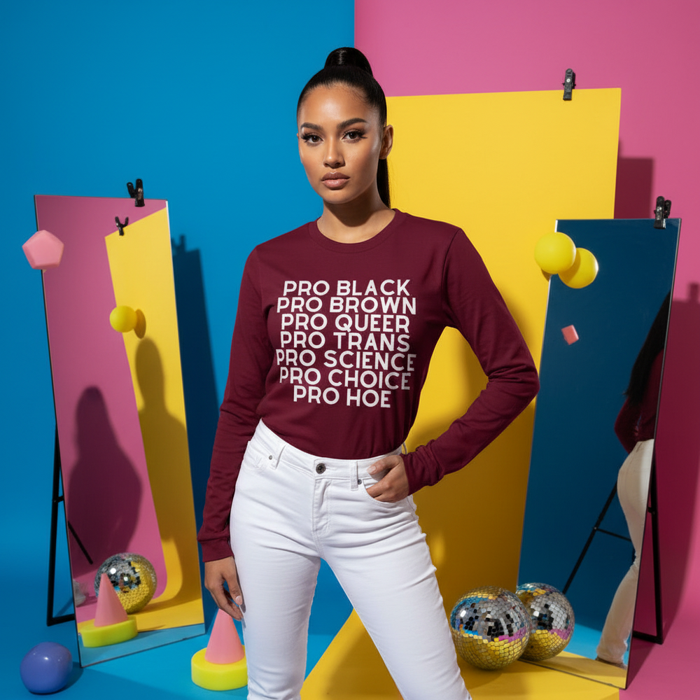 Model wearing a burgundy long-sleeve shirt reading “PRO BLACK PRO BROWN PRO QUEER PRO TRANS PRO SCIENCE PRO CHOICE PRO HOE”