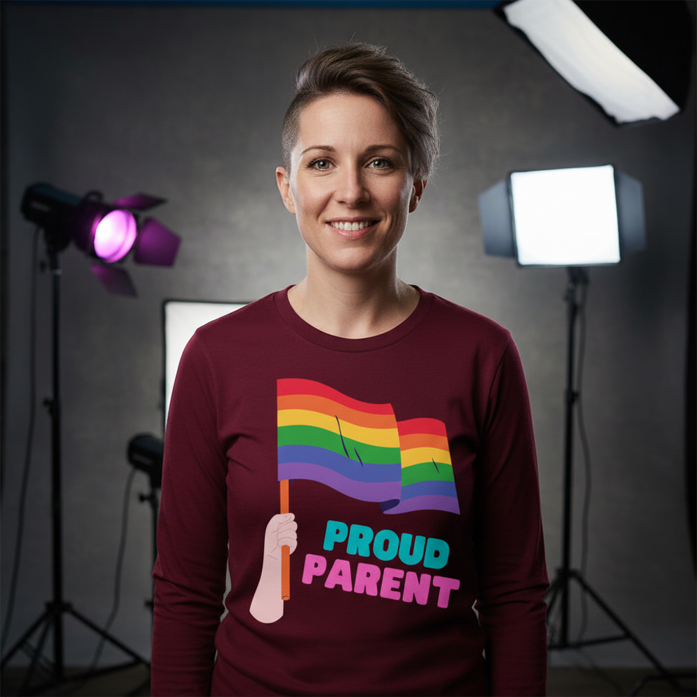 Front-facing person wearing a burgundy long-sleeve shirt with rainbow flags and “PROUD PARENT” text