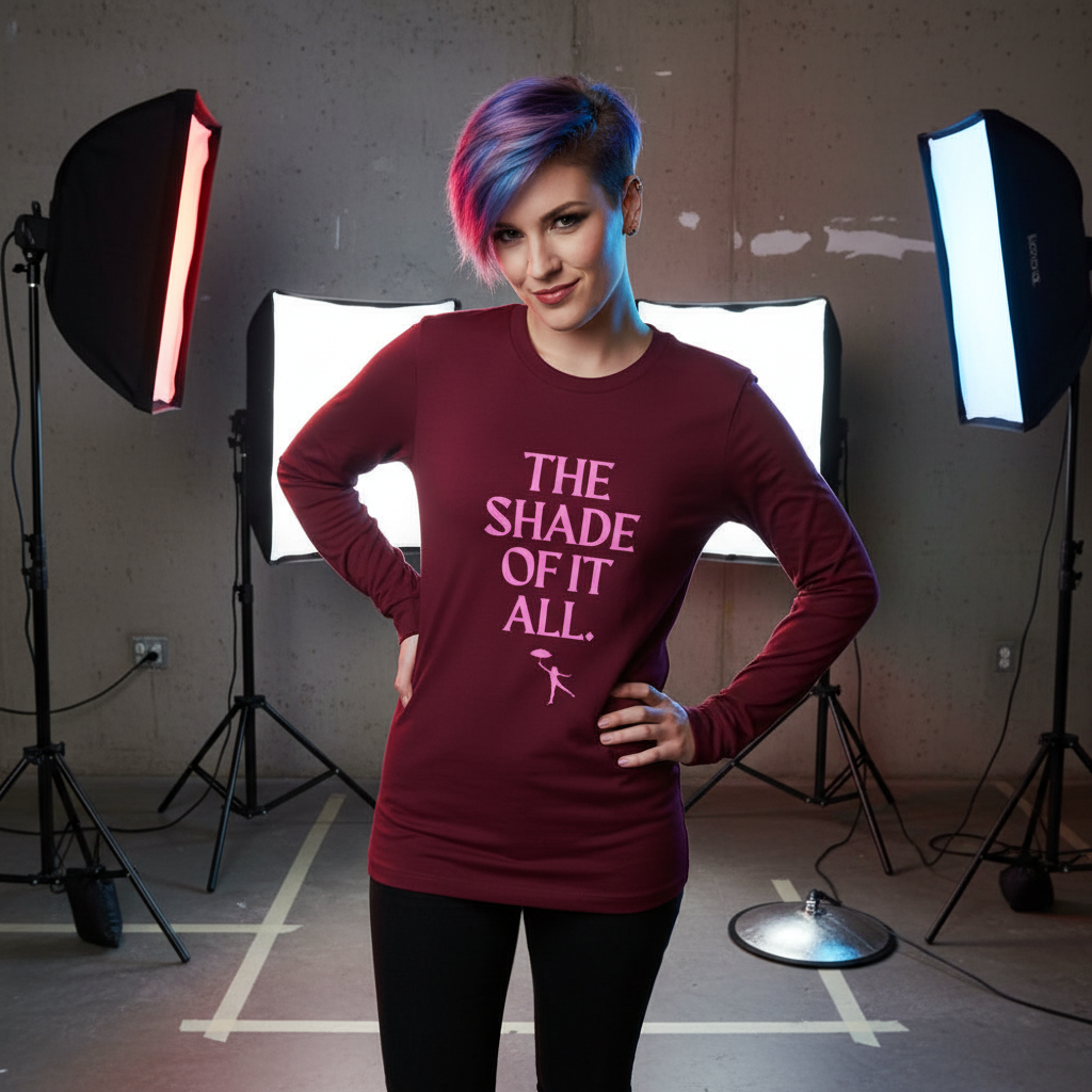 Model wearing a burgundy long-sleeve shirt reading “THE SHADE OF IT ALL.”