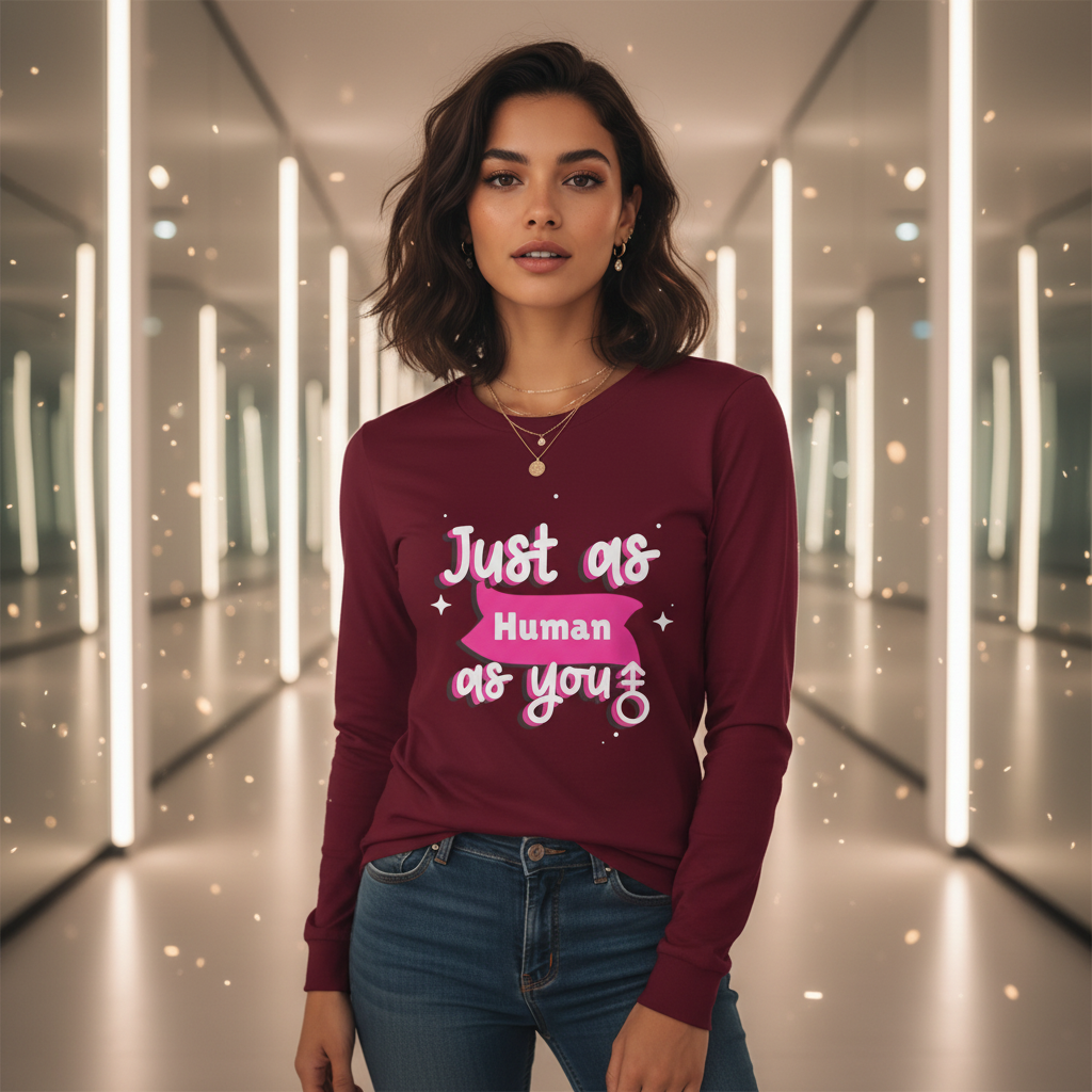 Young woman in a Just As Human As You Unisex Long Sleeve T-Shirt, embodying pride and self-expression. The shirt's bold message and chic style reflect Queer In The World's empowering ethos.