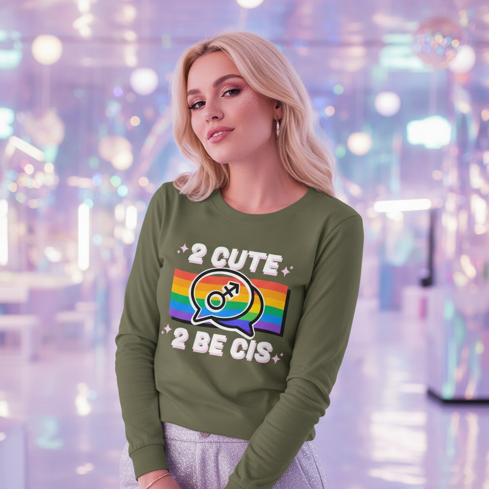 Model wearing an olive-green long-sleeve shirt reading “2 CUTE 2 BE CIS” with a rainbow gender-symbol graphic
